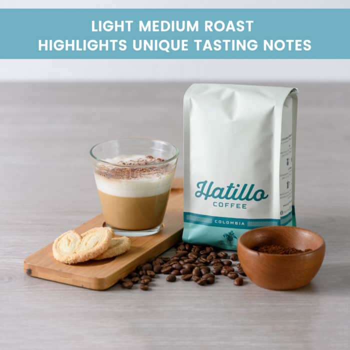 picture showing a 12 oz bag of colombian specialty coffee by Hatillo Coffee next to roasted beans, cookies and a prepared coffee beverage and with a banner that reads "light medium roast highlights unique tasting notes"